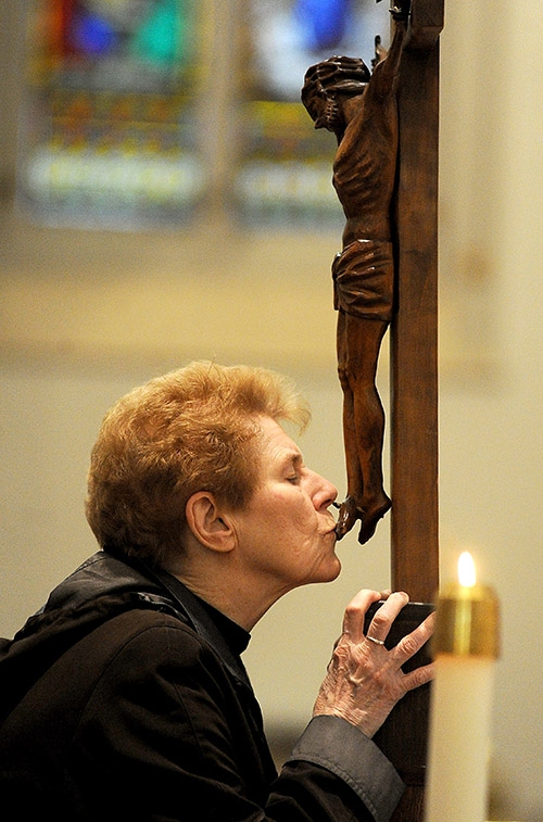 Sister Denise Roche venerates at the cross during the Solemn Celebration of the Lord's Passion on Good Friday at St. Joseph Cathedral. (Dan Cappellazzo/Staff Photographer)